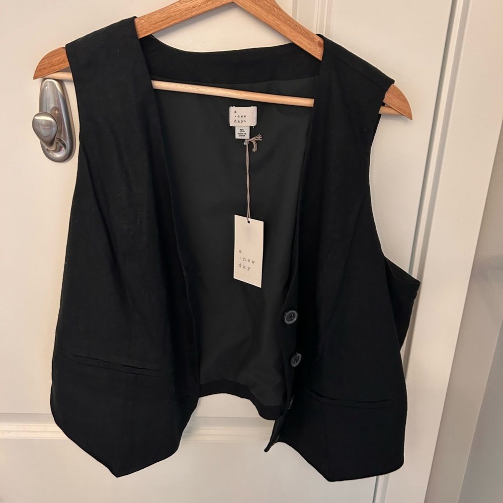 A New Day black vest